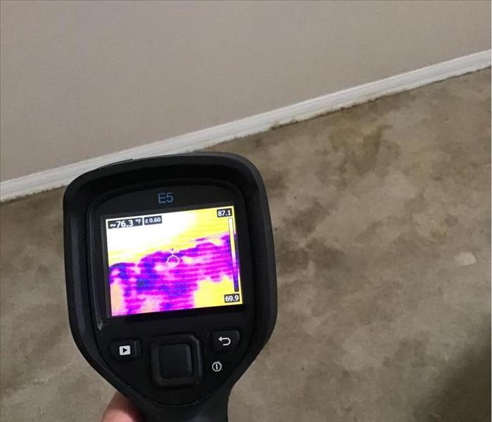 Thermal camera detecting moisture on floor and in wall.