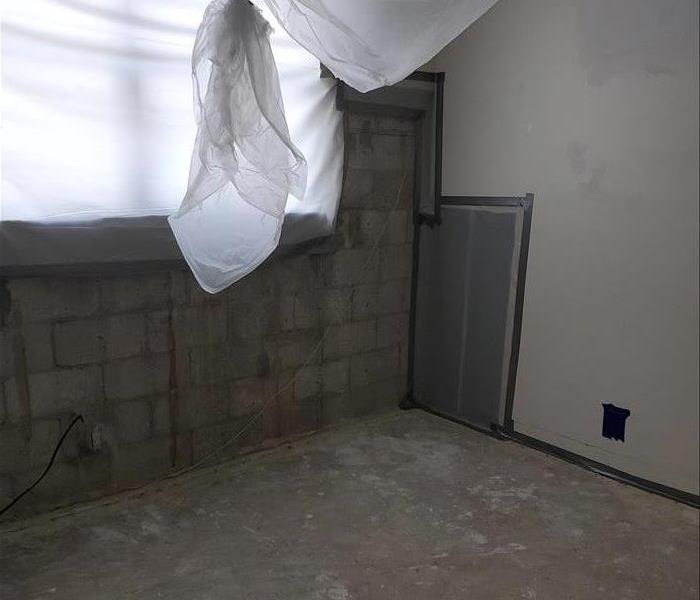 Room with removed dry wall and carpet.
