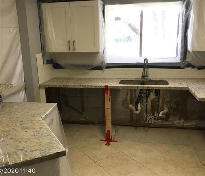 A kitchen that is being treated for mold is shown